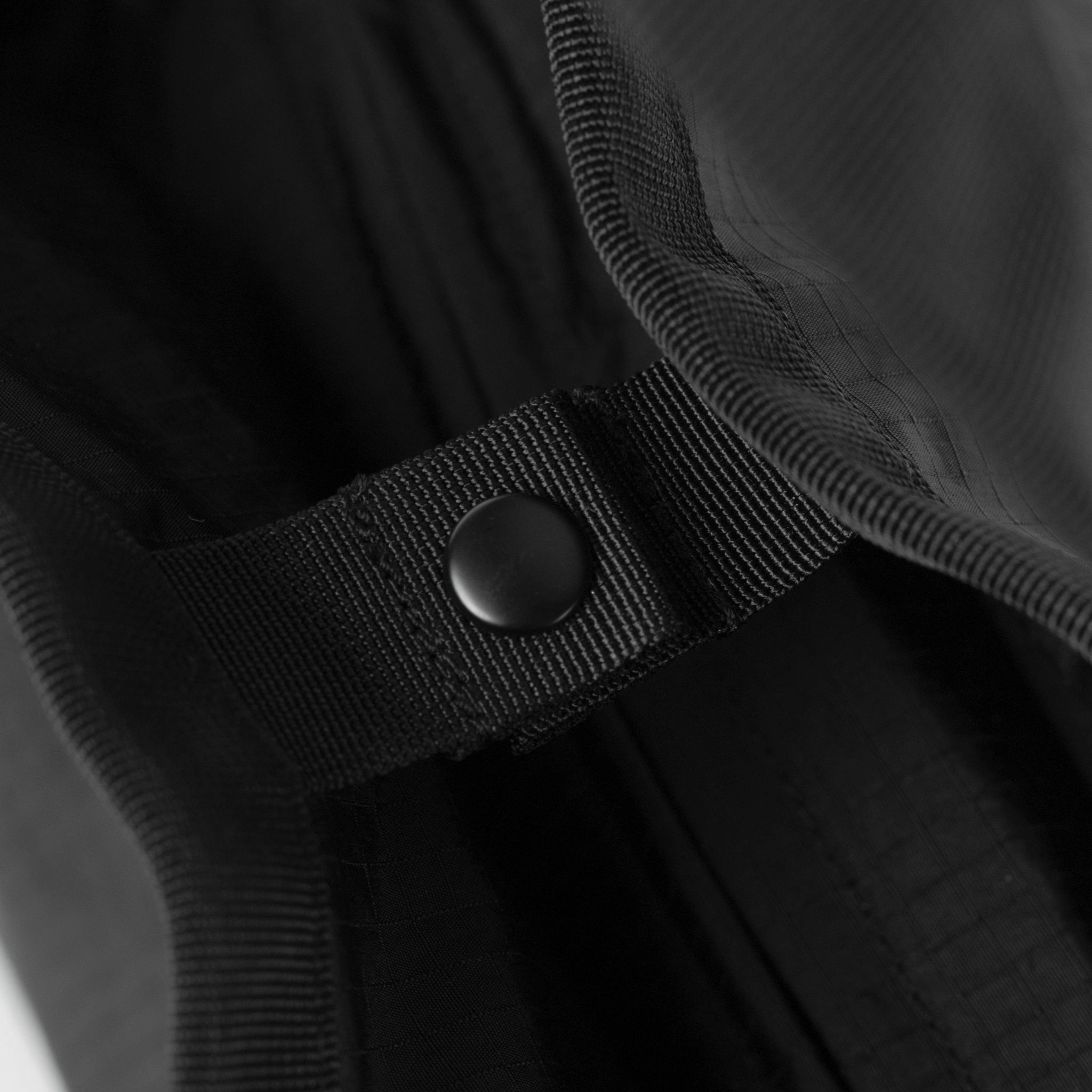 Inside view of the Grid Tote Bag Black Shoulder Bag showing zipper closure and press button detail.