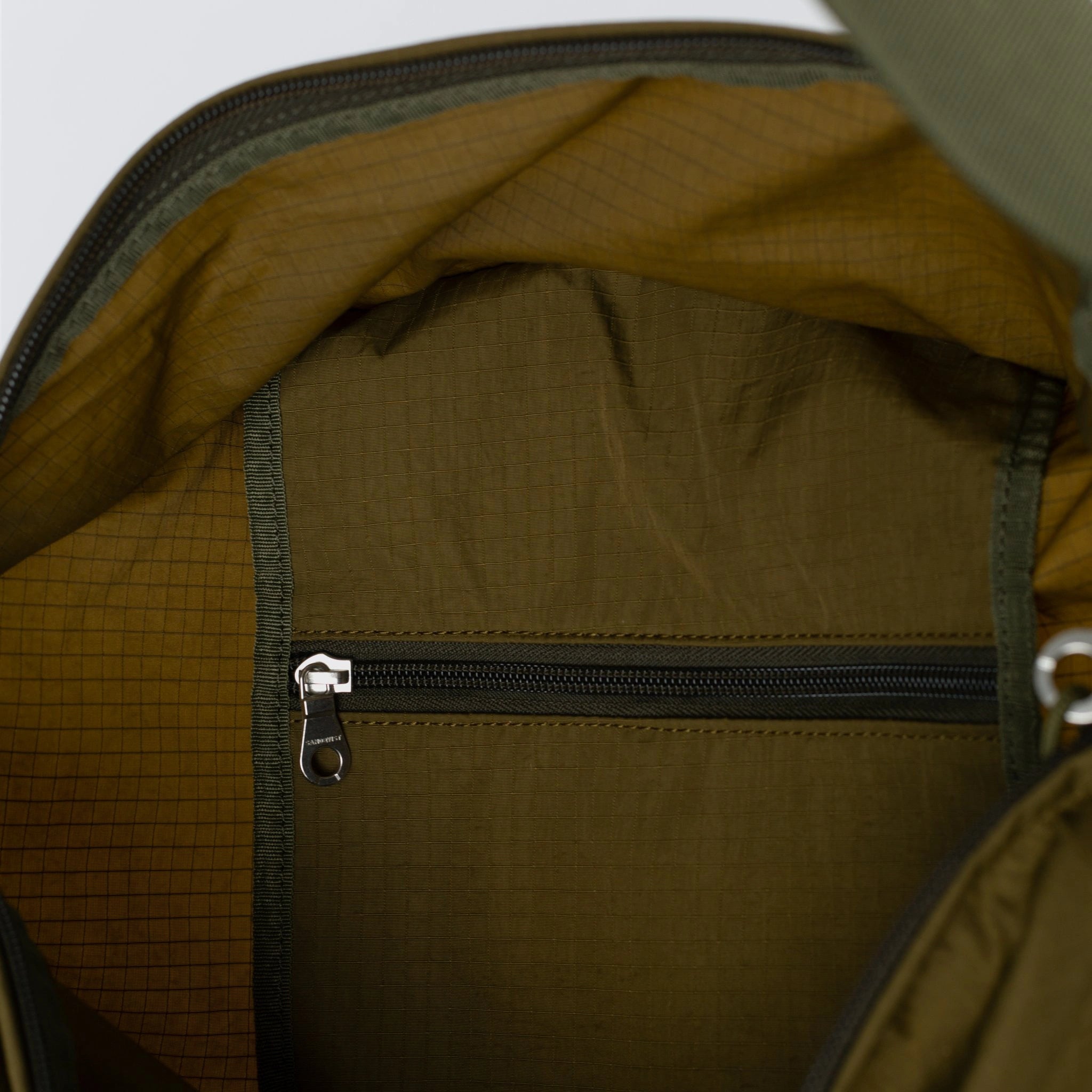 Interior view of Grid Tote Bag Olive Shoulder Bag showing zip pocket and expandable space.