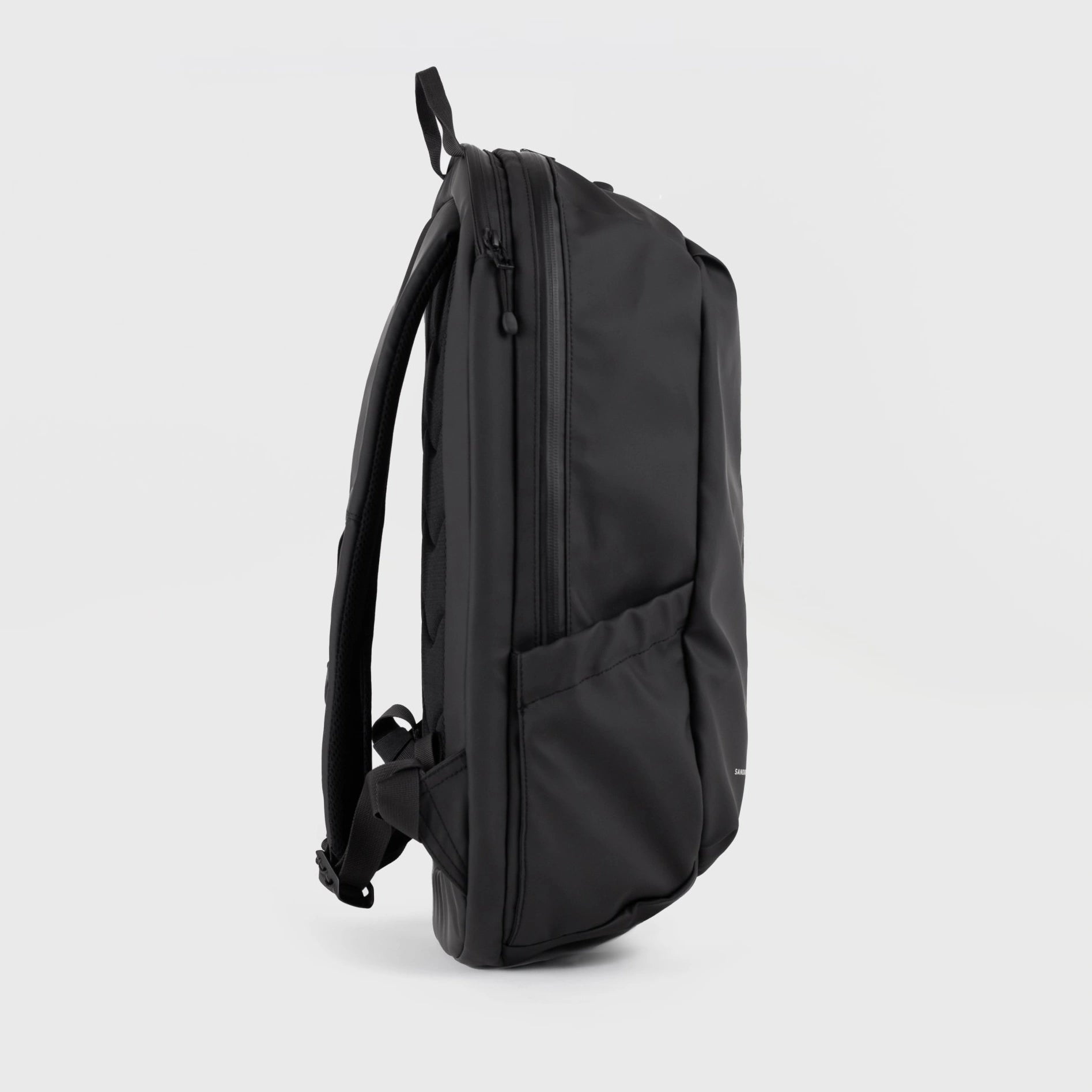 Stream Zipper Backpack Black Backpack side view, featuring durable waterproof material and adjustable padded straps.