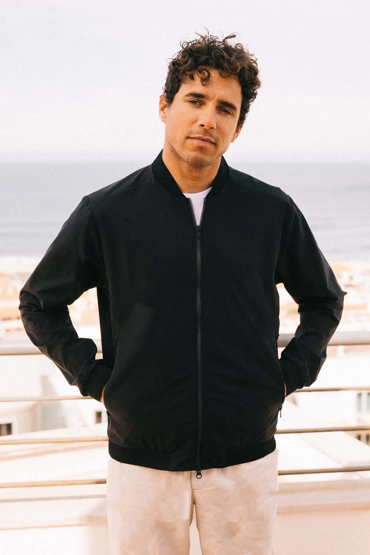 Man wearing Campo II Graphite Jacket, a lightweight windproof and water-resistant summer jacket.