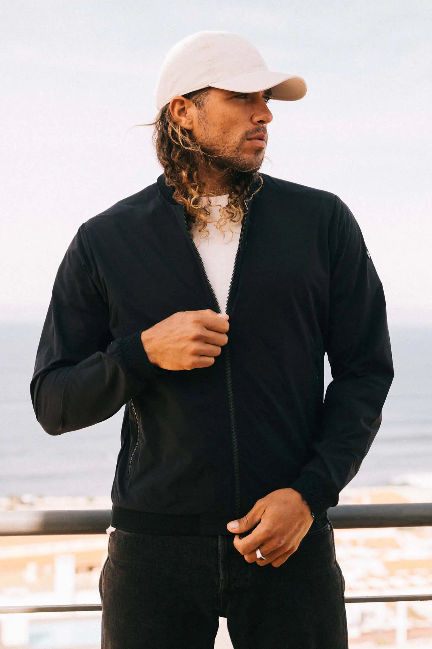 Campo II Graphite Jacket worn by man with long hair, showcasing a lightweight, windproof design.