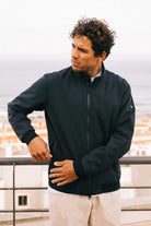 Man wearing Plain II Midnight Jacket with a modern style, showcasing windproof and waterproof features.