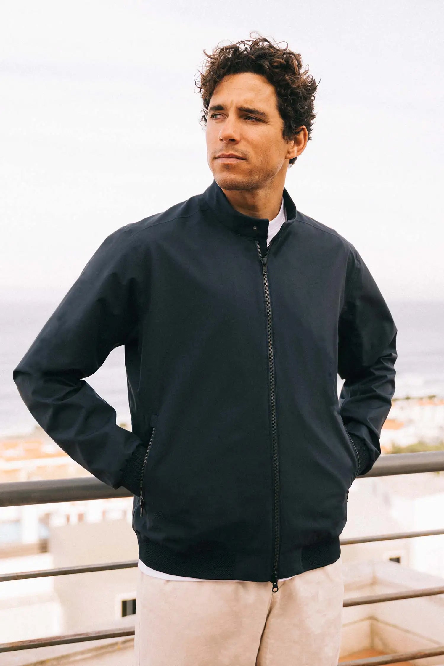 Model wearing the Plain II Midnight Jacket, a lightweight windproof and waterproof summer jacket.