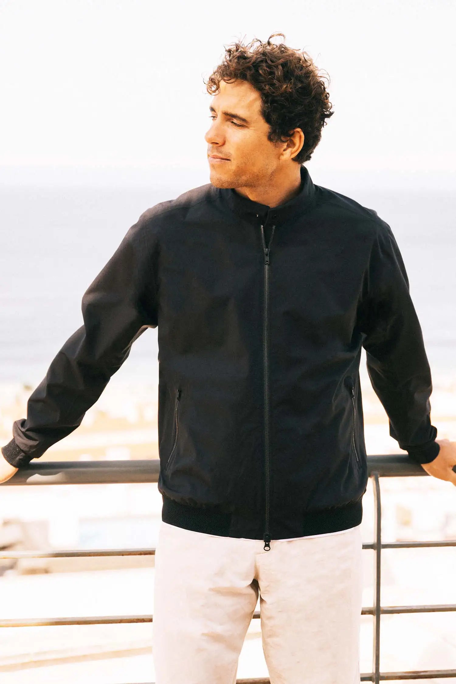 Man wearing a Plain II Onyx Jacket, stylish and versatile for summer and business looks.