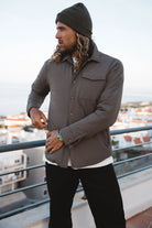 Man wearing Trip II Major Brown Overshirt, a lightweight windproof and water repellent jacket.