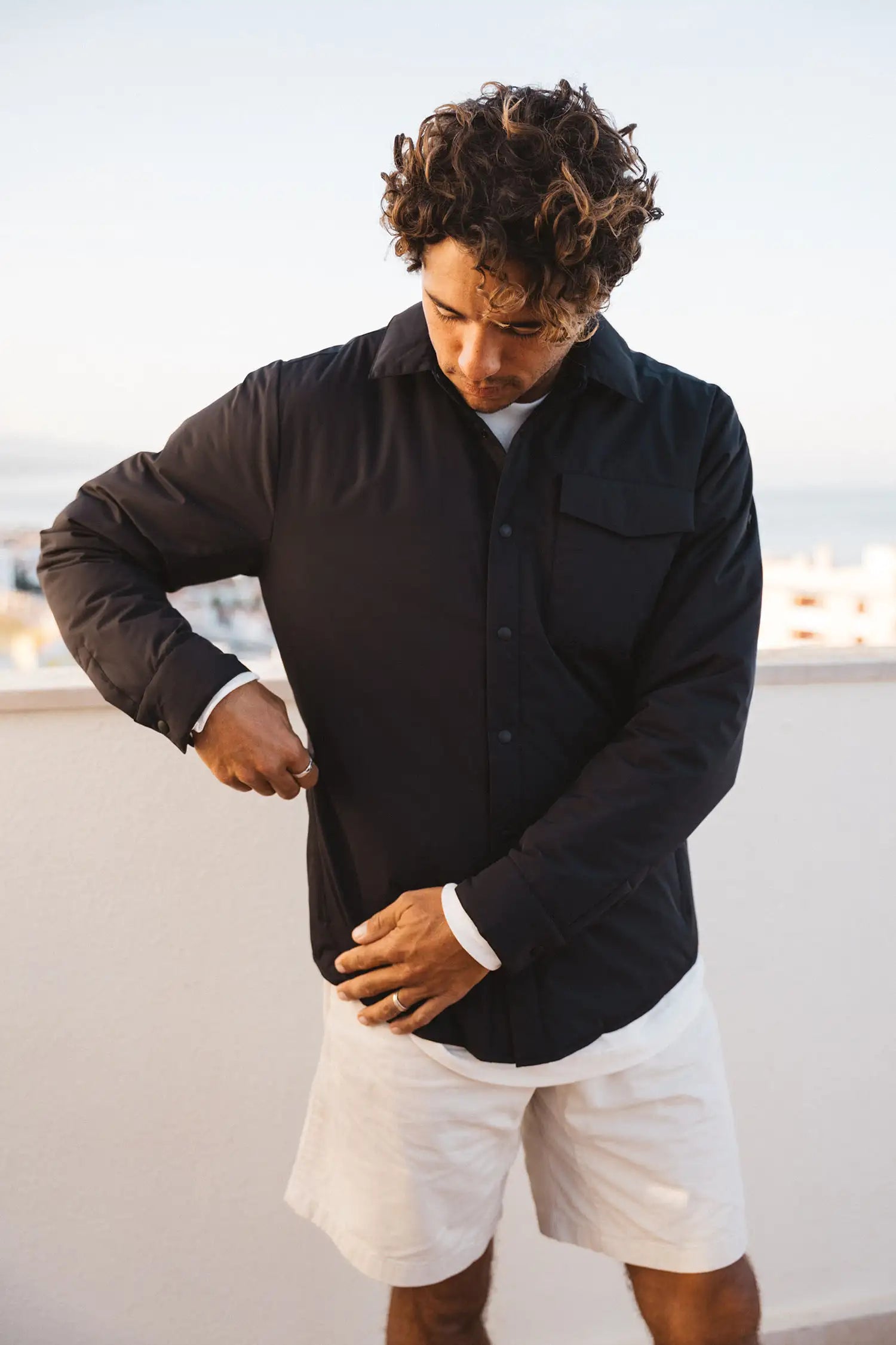 Model wearing Trip II Graphite Overshirt, a lightweight windproof and water repellent summer jacket.