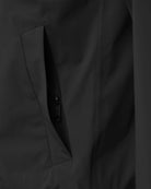 Close-up of a zippered pocket on the Era Apex Graphite Jacket, showcasing its sleek design and functionality.