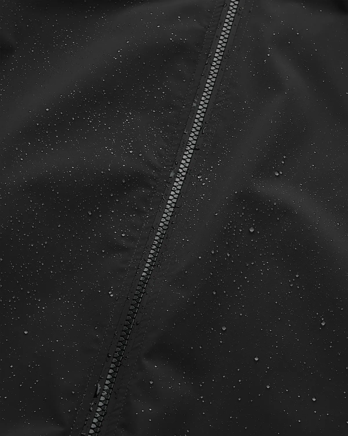 Close-up of the Era Apex Graphite Jacket showing water-resistant fabric and zip closure detail.