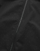 Close-up of the Era Apex Graphite Jacket showing water-resistant fabric and zip closure detail.