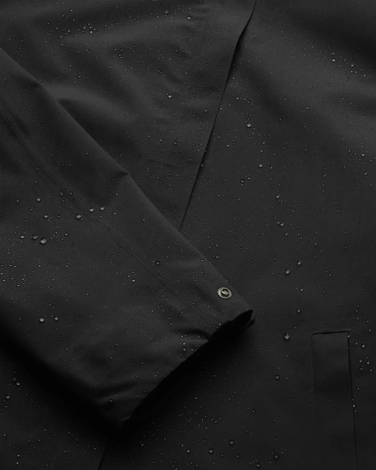 Flair II Short Onyx Jacket showing water droplets on windproof and waterproof fabric