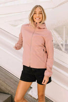 Woman wearing the Veil II Flush Pink Jacket, showcasing its stylish design and comfortable fit.