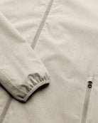 Close-up of the Veil II Khaki Jacket showing water droplets on the fabric, highlighting its waterproof feature.