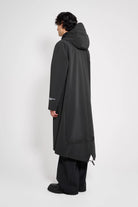 Martins Parka Black Raincoat showing a man wearing a black fishtail parka from the back.