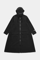 Mosebacke Long Patch Black Raincoat, waterproof A-line silhouette with adjustable hood and flap pockets.