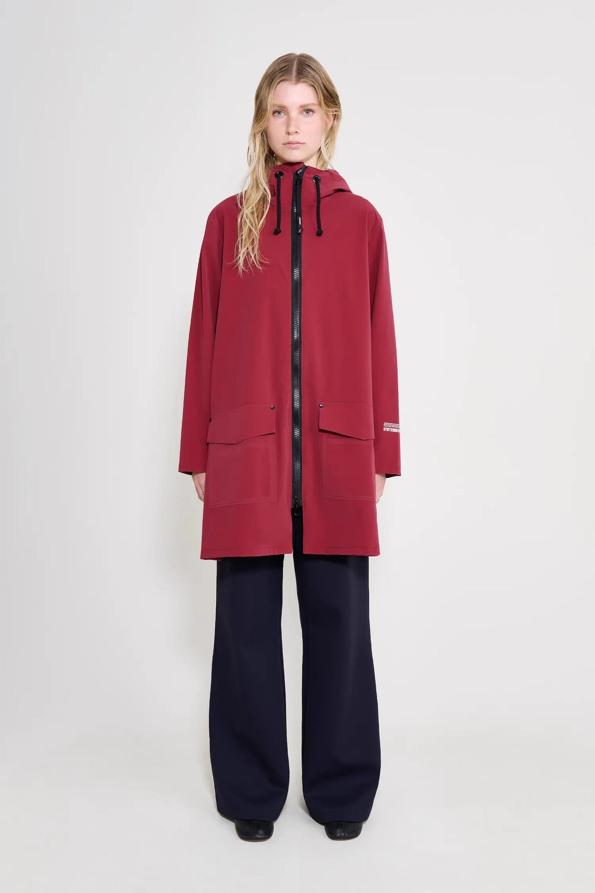 Mosebacke Patch Burgundy Raincoat featuring adjustable hood and A-line silhouette, designed for waterproof protection.