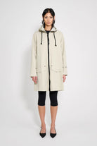 Mosebacke Patch Pelican Raincoat showcased on model, featuring A-line silhouette and adjustable hood.