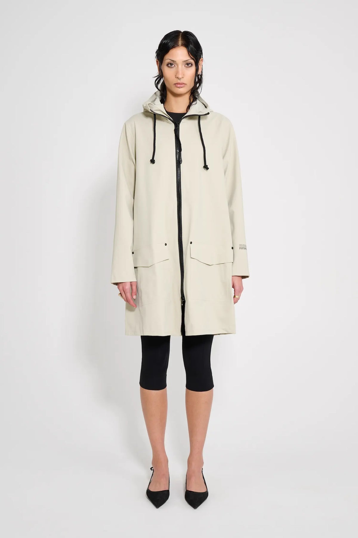 Mosebacke Patch Pelican Raincoat showcased on model, featuring A-line silhouette and adjustable hood.