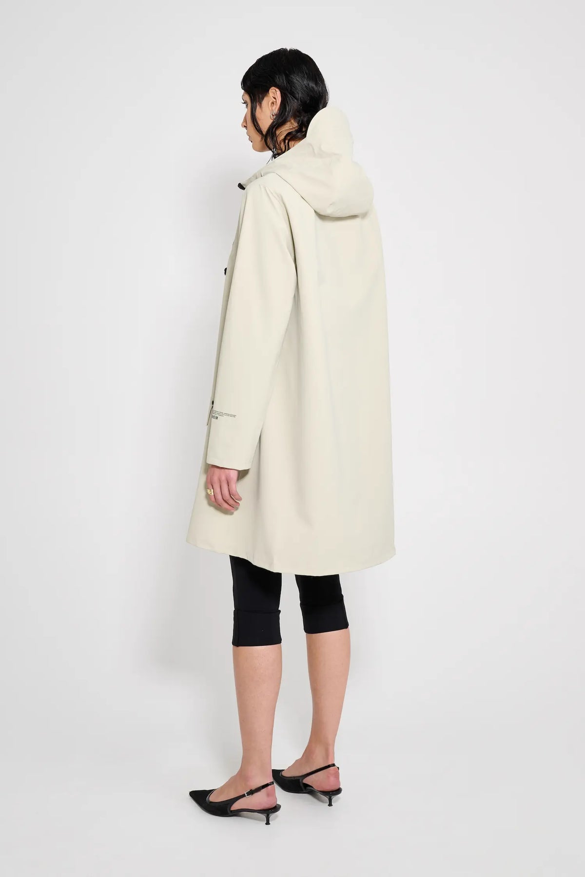 Mosebacke Patch Pelican Raincoat shown from the back, showcasing its waterproof fabric and A-line silhouette.