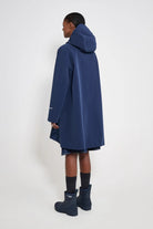 Mosebacke Patch Navy Raincoat displayed from the back, highlighting its A-line silhouette and adjustable hood.