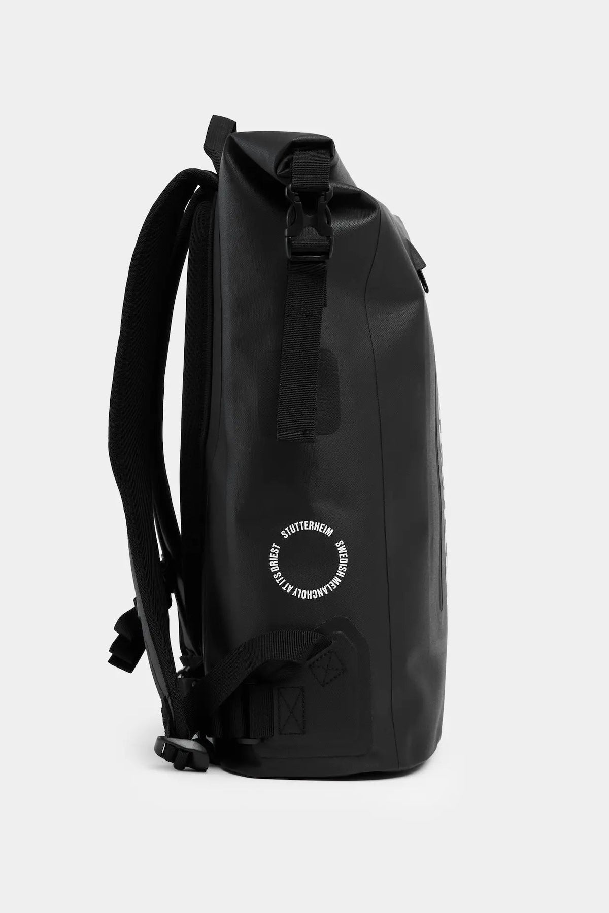 Rain Rolltop 25L Black Backpack side view showcasing waterproof design and rolltop closure.