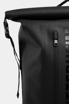 Close-up of Rain Rolltop 25L Black Backpack showing waterproof zipper and rolltop design.