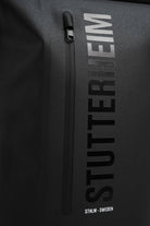 Rain Rolltop 25L Black Backpack with waterproof design and stylish STUTTERHEIM branding.