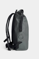 Side view of the Rain Rolltop 25L Green Backpack showcasing its waterproof material and adjustable straps.