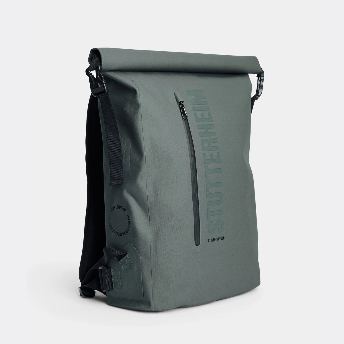 Rain Rolltop 25L Green Backpack featuring waterproof design and rolltop opening, styled in Stockholm.