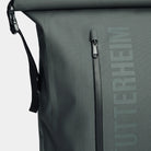 Close-up of the waterproof zippers on the Rain Rolltop 25L Green Backpack showing durability and design features.