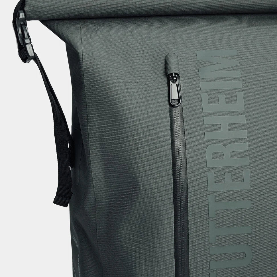 Close-up of the waterproof zippers on the Rain Rolltop 25L Green Backpack showing durability and design features.