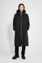 Stockholm Long Matte Black Winter Coat worn by a model, showcasing its sleek design and waterproof features.