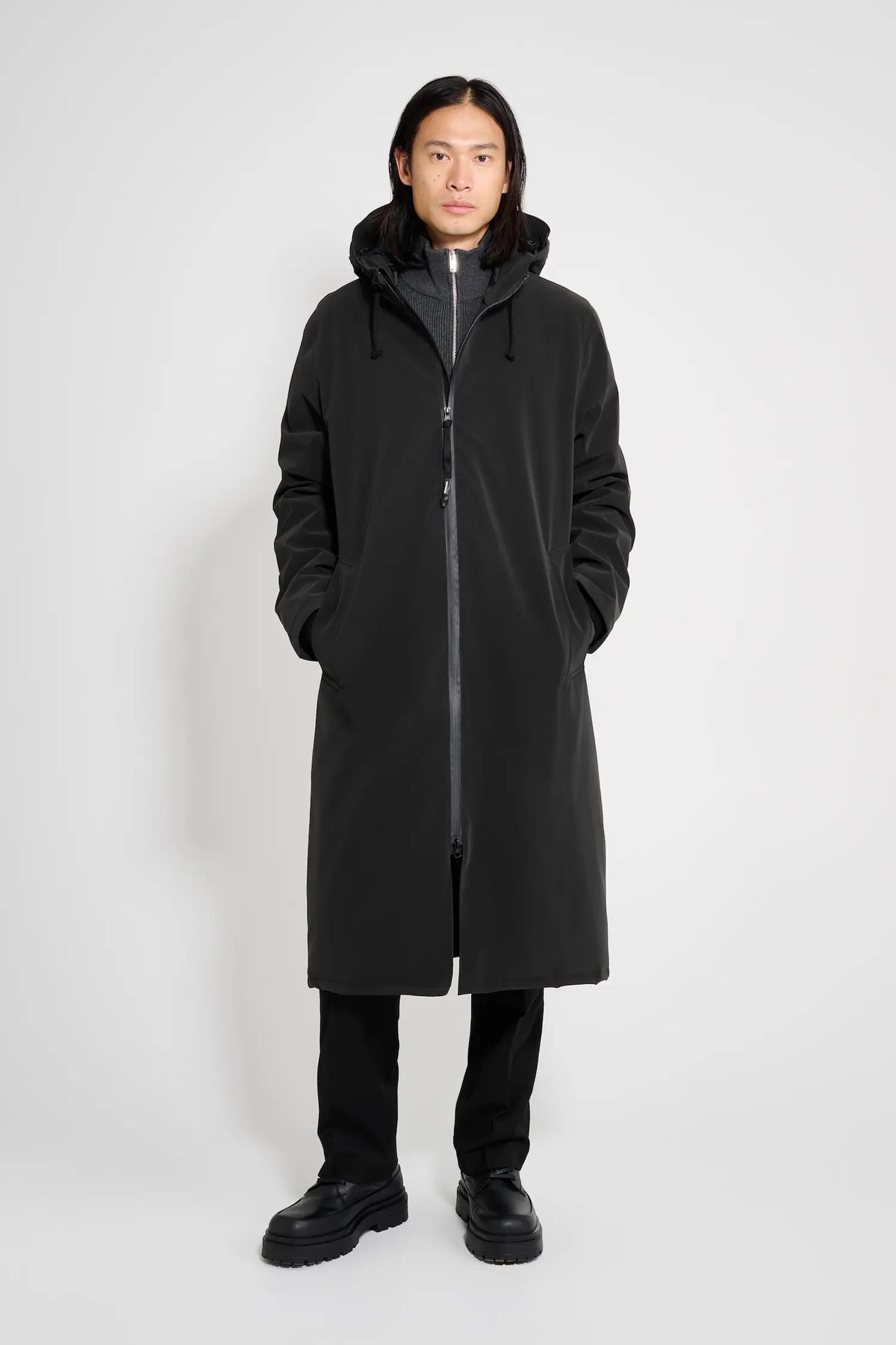 Stockholm Long Matte Black Winter Coat worn by a model, showcasing its sleek design and waterproof features.