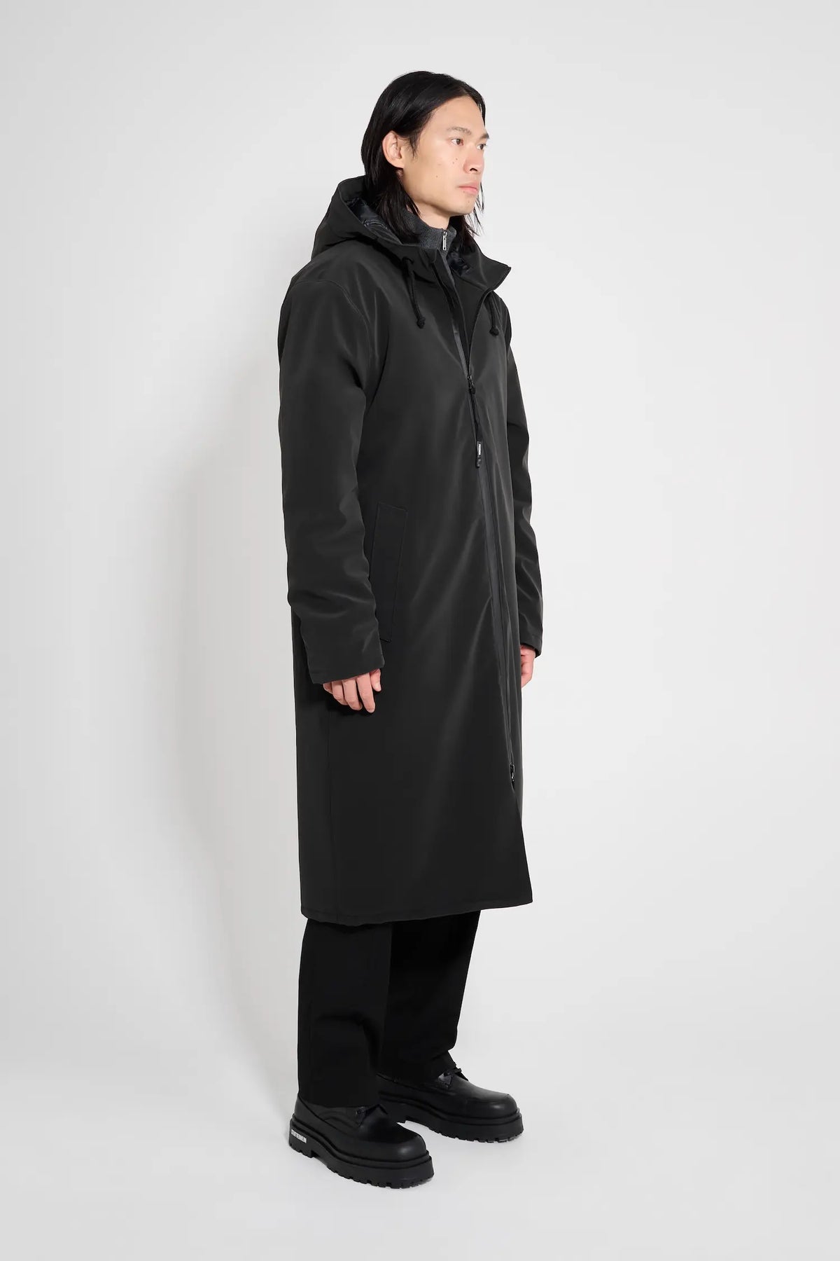 Model wearing Stockholm Long Matte Black Winter Coat, showcasing its oversized fit and adjustable hood.