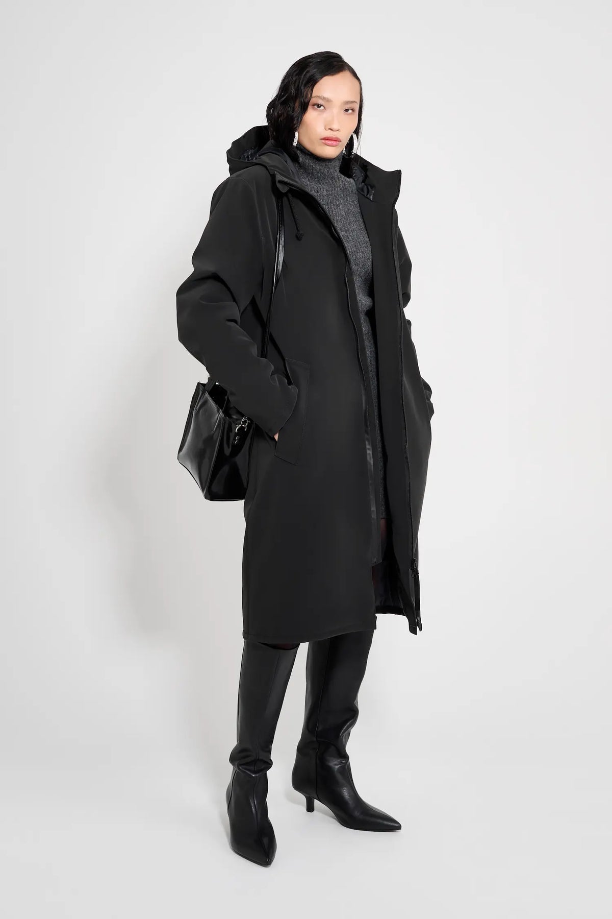 Model wearing the Stockholm Long Matte Black Winter Coat with a stylish look, showcasing comfort and functionality.