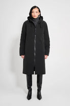 Stockholm Long Matte Black Winter Coat on model, showcasing unisex design and adjustable hood.