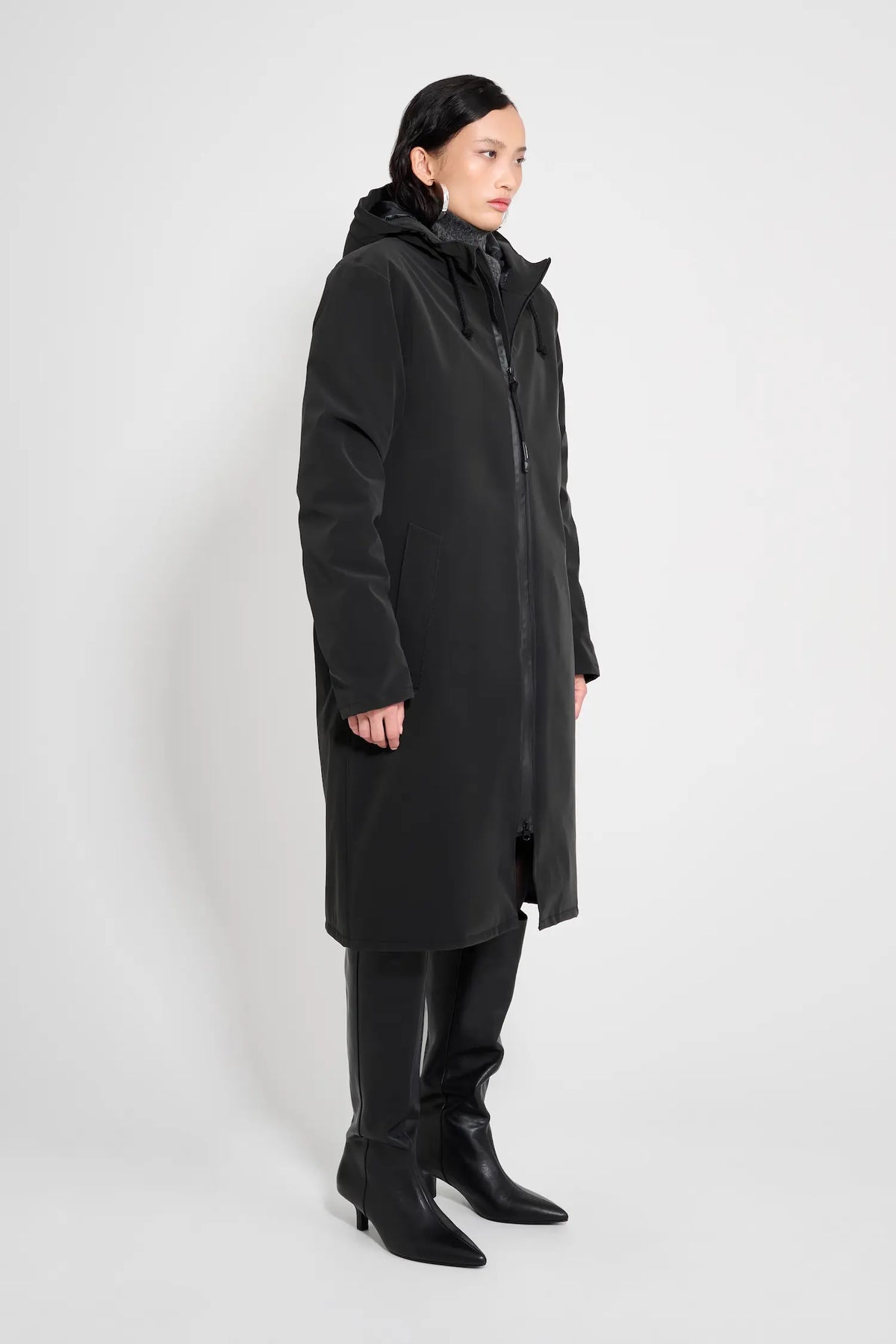 Stockholm Long Matte Black Winter Coat displayed on a model, showcasing its oversized fit and adjustable hood.