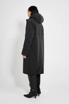 Stockholm Long Matte Black Winter Coat displayed from the back, showcasing its oversized fit and adjustable hood.