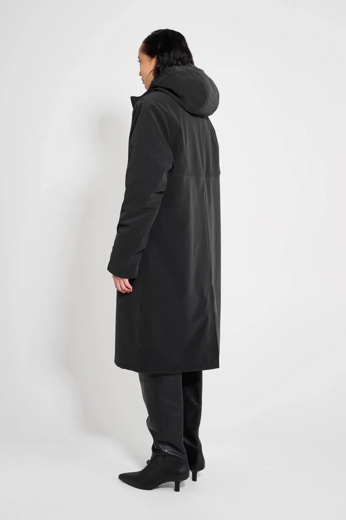Stockholm Long Matte Black Winter Coat displayed from the back, showcasing its oversized fit and adjustable hood.