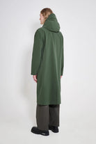 Stockholm Long Patch Matte Green Raincoat shown from the back with adjustable hood and oversized fit.
