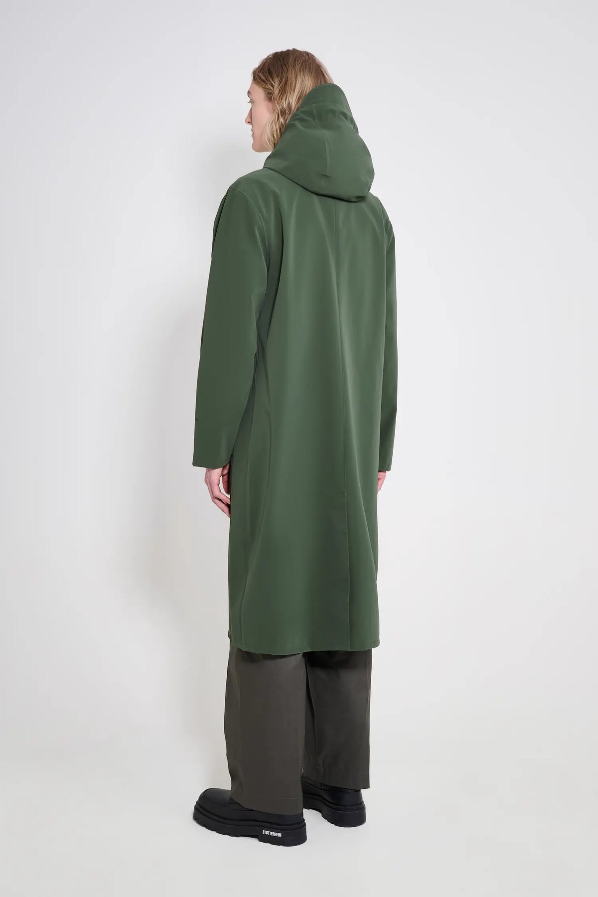 Stockholm Long Patch Matte Green Raincoat shown from the back with adjustable hood and oversized fit.