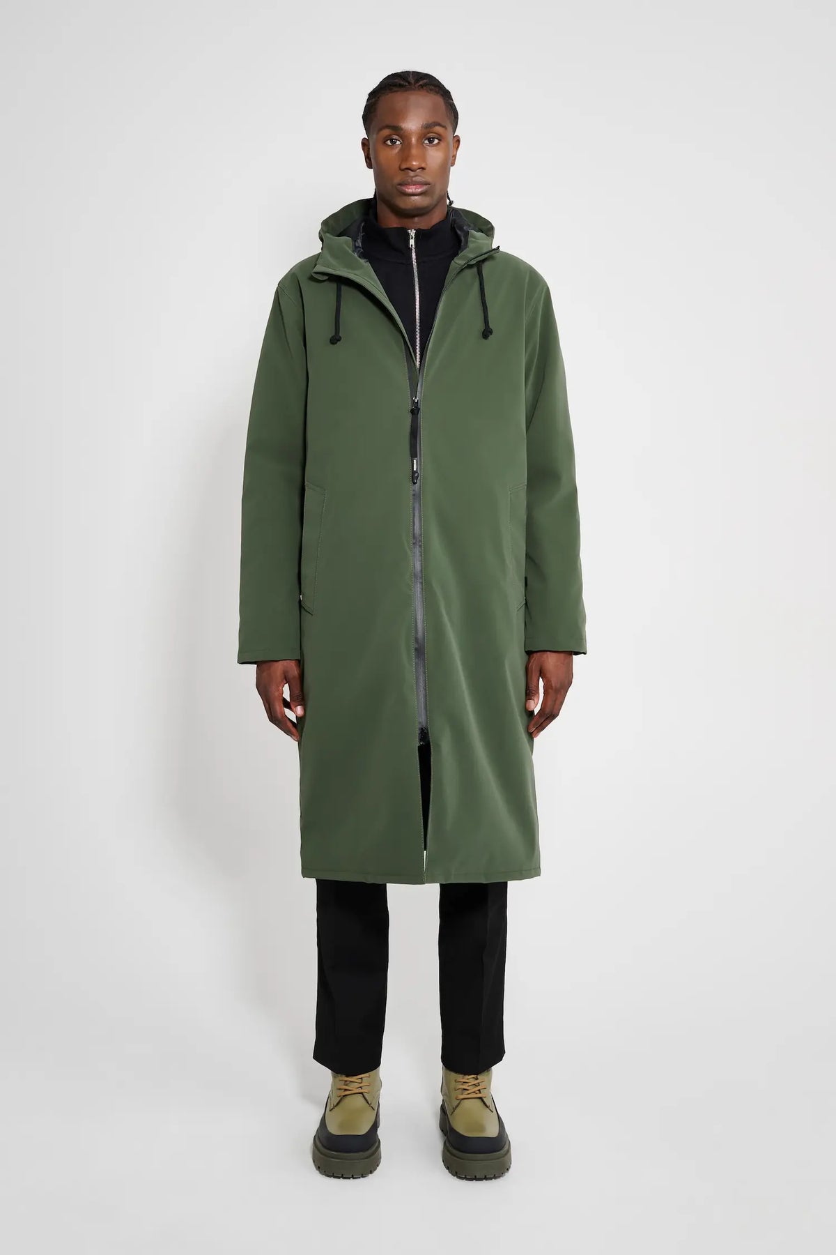 A model wearing the Stockholm Long Matte Green Winter Coat featuring a straight oversized fit and adjustable hood.