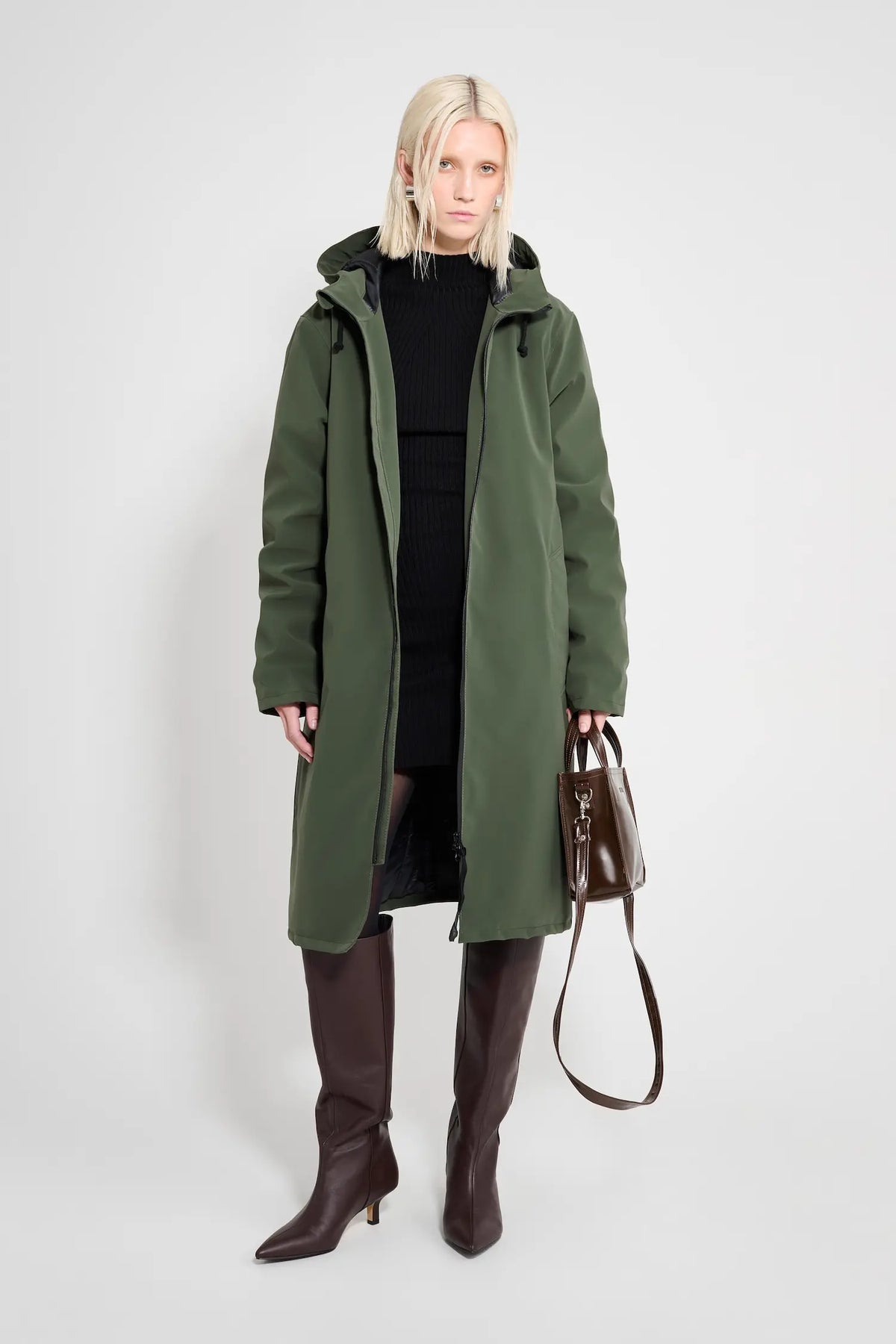 Stockholm Long Matte Green Winter Coat worn by a model, showcasing its oversized fit and adjustable hood.