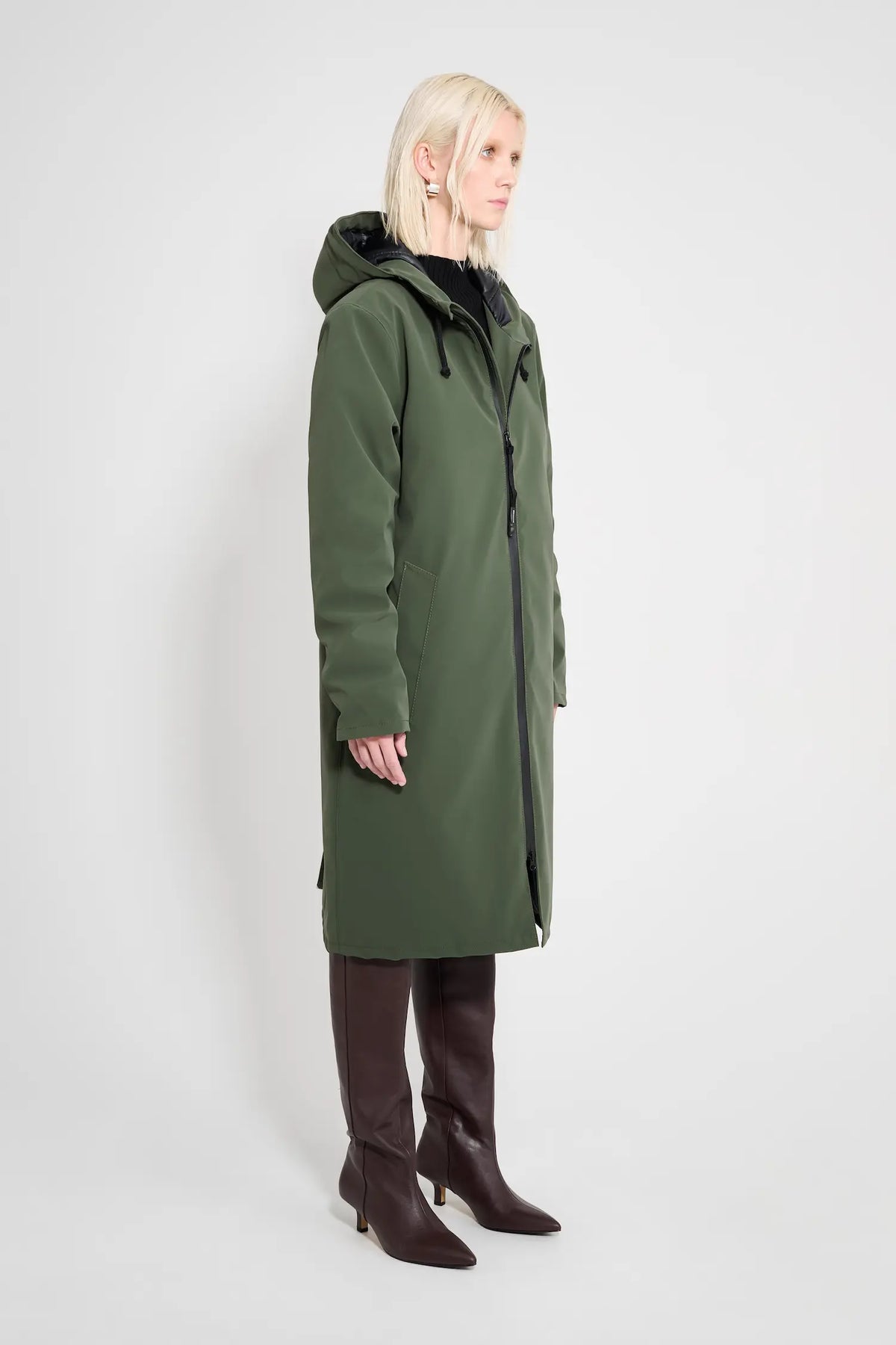 Stockholm Long Matte Green Winter Coat displayed on a model, showcasing its sleek design and adjustable hood.