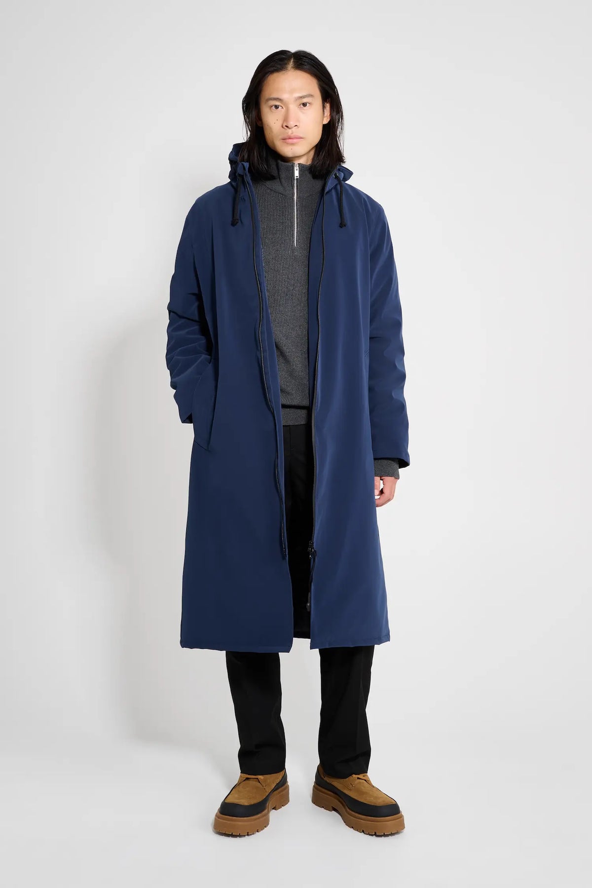 Stockholm Long Matte Navy Winter Coat modeled by a person in a plain background, showcasing its oversized fit and matte finish.