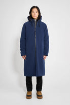 Stockholm Long Matte Navy Winter Coat on a model with an adjustable hood and knitted cuffs.