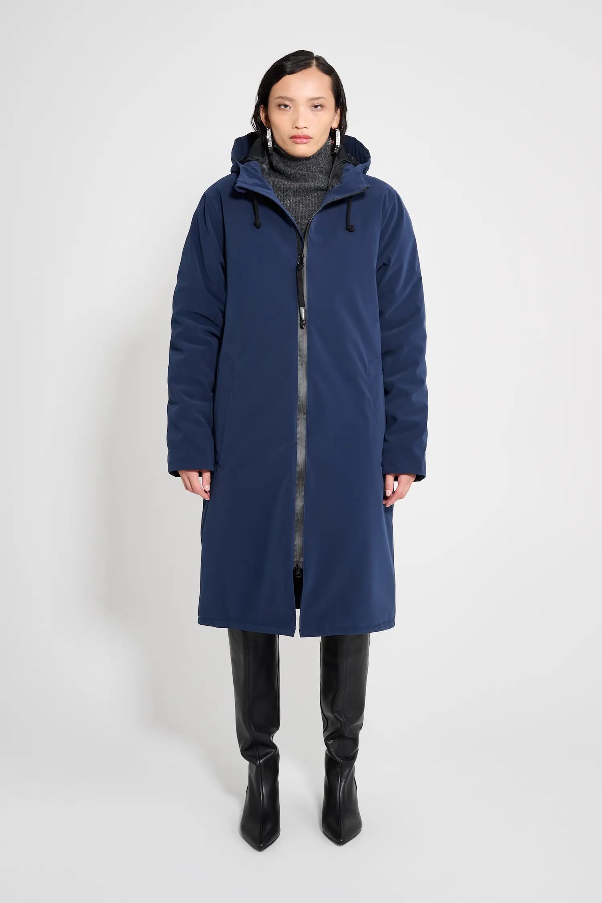 Stockholm Long Matte Navy Winter Coat on a model, showcasing its oversized fit and adjustable drawstring hood.