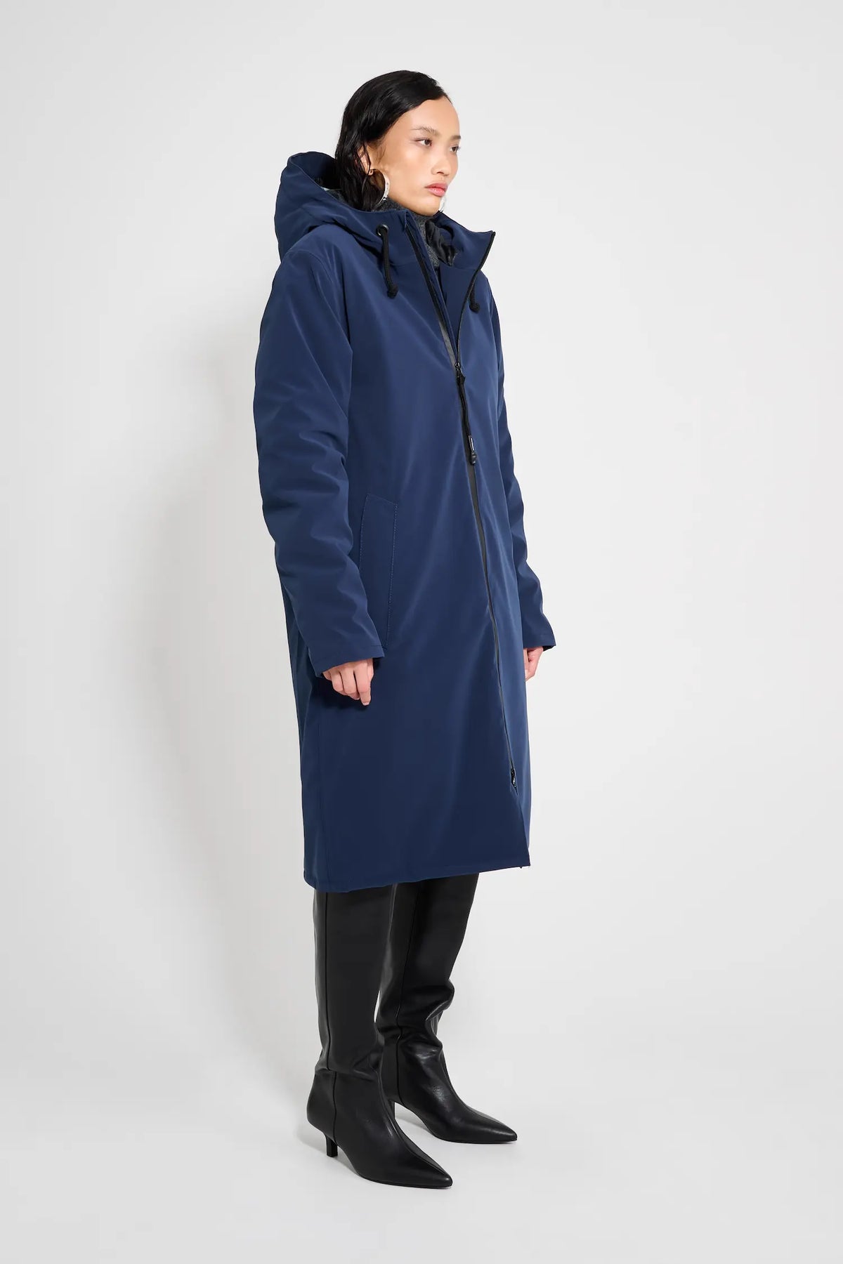 Stockholm Long Matte Navy Winter Coat worn by a model showcasing its oversized fit and adjustable hood.