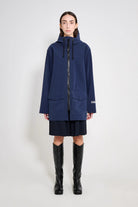 Stockholm Patch Navy Raincoat worn by a model, showcasing its oversized fit and waterproof features.