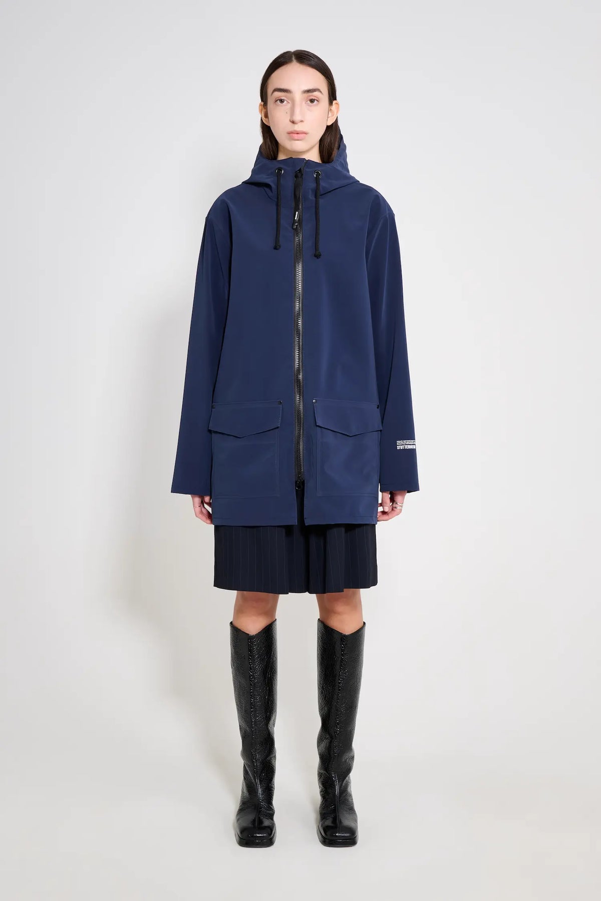 Stockholm Patch Navy Raincoat worn by a model, showcasing its oversized fit and waterproof features.