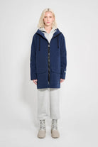 Model wearing the Stockholm Patch Navy Raincoat showcasing its oversized fit and waterproof features.